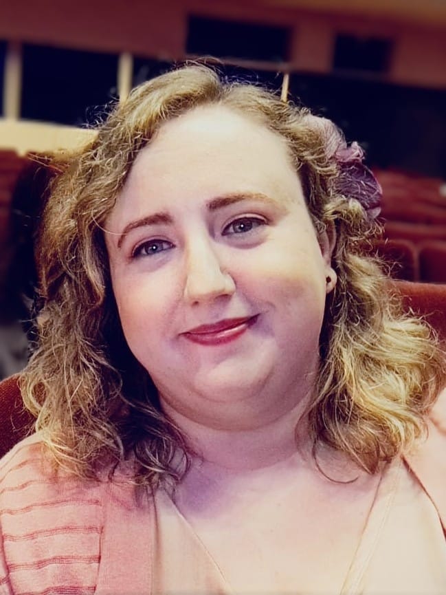 A photo of rebecca peacock smiling for the camera