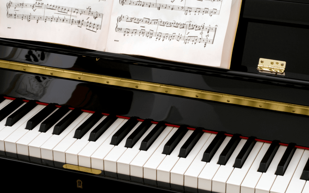A piano with music sheets on it