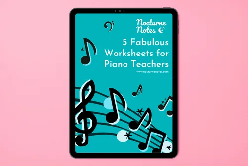 freebie-5fabulous Top down view of a desk with a white iPad displaying the e-book of "5 Fabulous Worksheets for Piano Teachers" from Nocturne Notes.